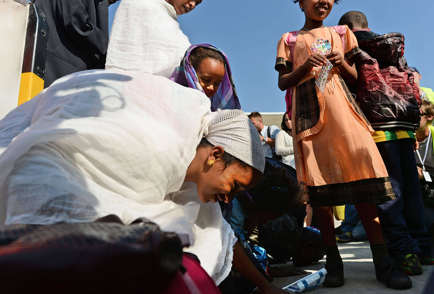 New Jewish immigrants from Ethiopia land at Ben Gurion Airport and bend down to kiss the ground in honor of their arrival in the land of Israel. Photo: Kobi Gideon, GPO