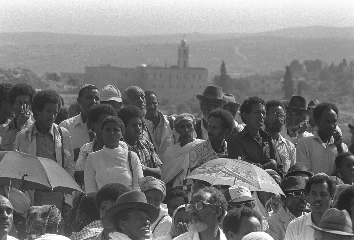 MEMBERS OF ETHIOPIAN COMMUNITY LISTENING TO AN ADDRESS BY ELDERS DURING TREE-PLANTING CEREMONY FOR THEIR BROTHERS WHO DIED EN ROUTE TO ISRAEL, RAMAT RAHEL, JERUSALEM. Photo by: Nati Hernik, GPO